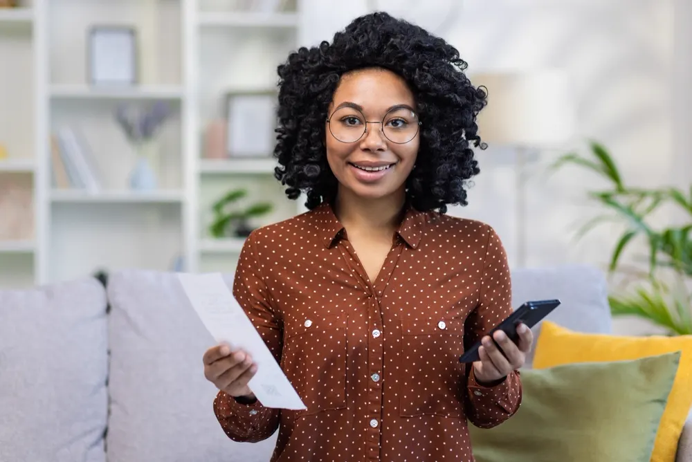 Employee reading her payslip at home